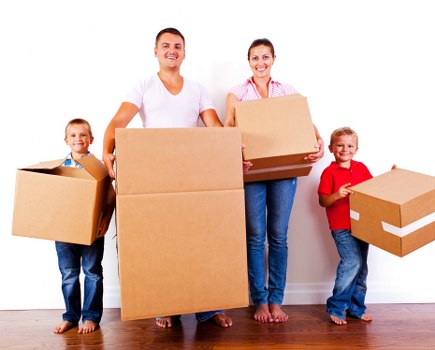Professional movers carrying furniture through a narrow staircase in Barnsbury
