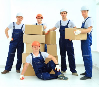 Local movers carrying furniture from a Barnsbury flat