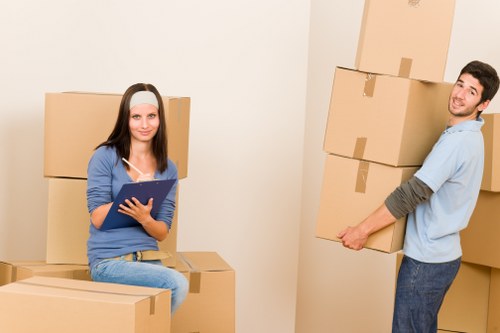 Professional movers handling desks and boxes during a commercial relocation